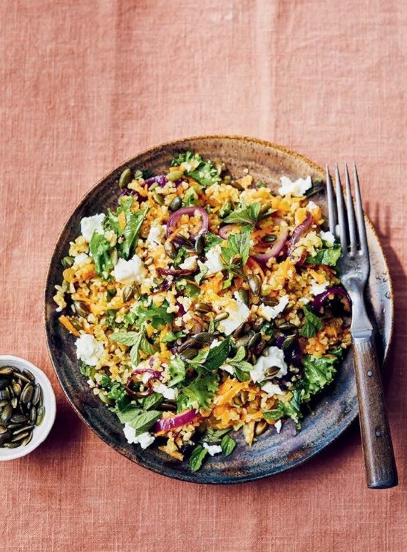 Lunchbox salad of carrots, bulgar and raisins with mustard and honey dressing