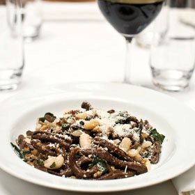 Maccheroncini di grano arso with duck sausage, cannellini beans & Swiss chard