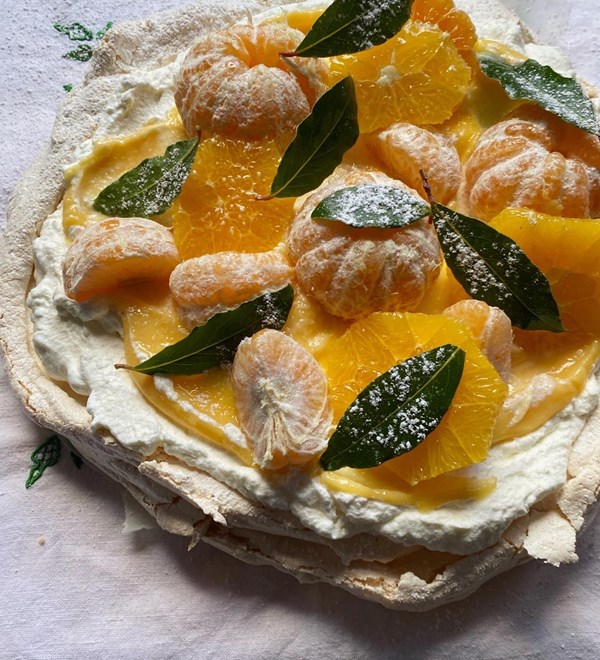 Mandarin curd Pavlova with frosted bay and yoghurt cream