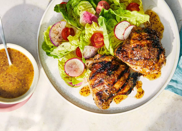 Maple and grainy mustard sauce with chicken thighs and green salad