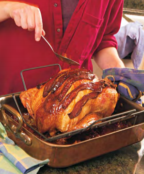 Maple-bacon glazed turkey with wild rice and cornbread stuffing and bourbon gravy