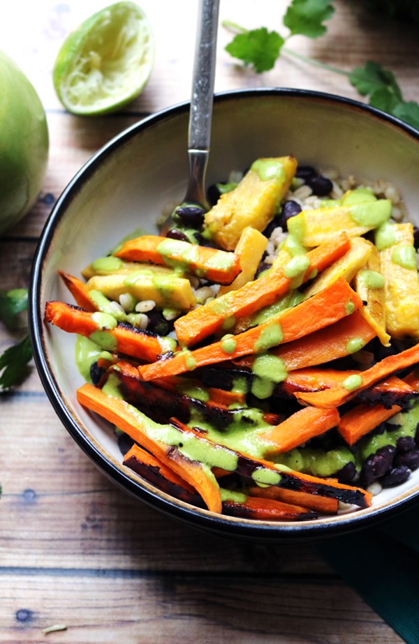 Maple-chipotle roasted sweet potato and plantain burrito bowls with mojo sauce