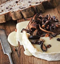Maple-planked Brie with mushroom-walnut ragout