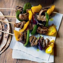 Marinated beef skewers with avocado and mango salad
