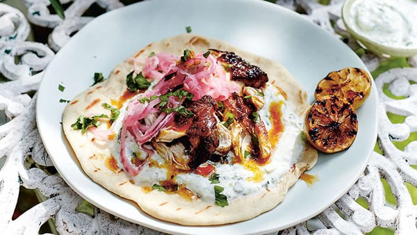 Marinated chicken with charred limes, saffron butter and soft flatbreads