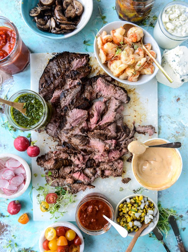Marinated grilled flank steak with toppings