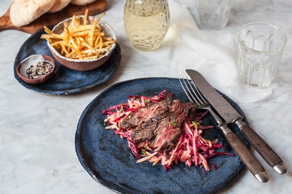 Marinated Irish skirt steak on a fresh roots salad and crispy matchstick fries