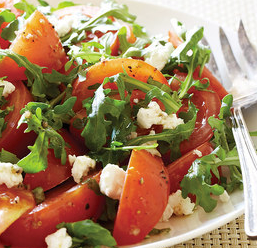 Marinated tomato salad with arugula and goat cheese