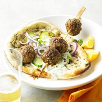 Meatballs with cucumber sauce on flatbread