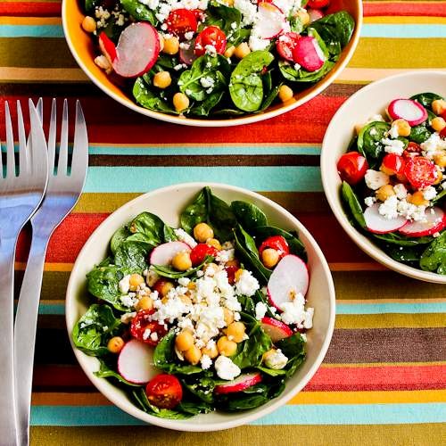 Mediterranean spinach salad with garbanzos, tomatoes, radishes, and sumac-lemon vinaigrette