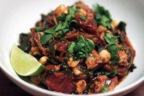 Melissa Clark’s spicy pork stew with hominy and collard greens