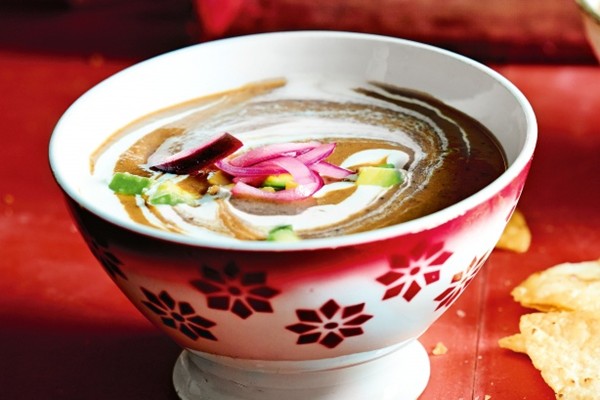 Mexican bean soup with tortilla chips and pickled red onions