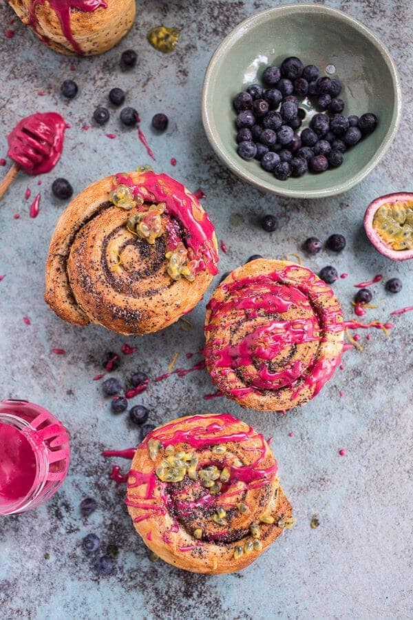 Meyer lemon poppy seed morning buns with blueberry passionfruit glaze