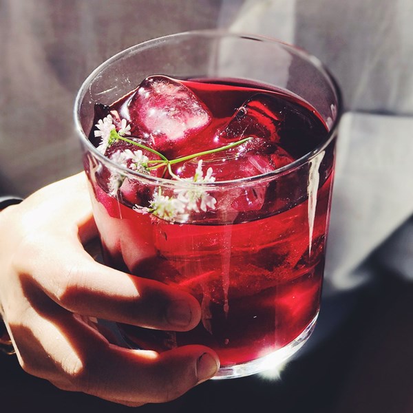 Mezcal cocktail with hibiscus and cilantro