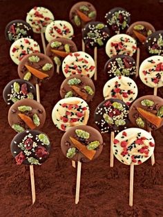 Milk chocolate lollipops with confit orange, crystallised pistachio & cocoa nibs