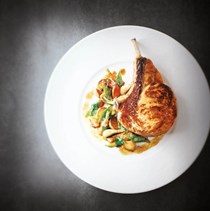 Milk-fed veal chops, tender young vegetables with spring garlic