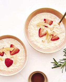 Millet porridge with strawberries, pine nuts, and rosemary syrup