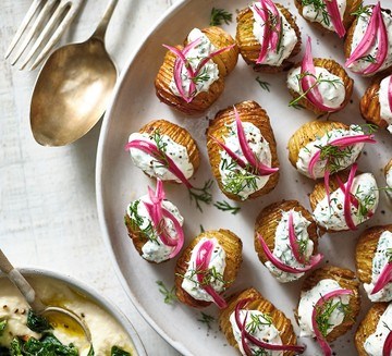Mini hasselbacks with soured cream, dill & pink pickled onions