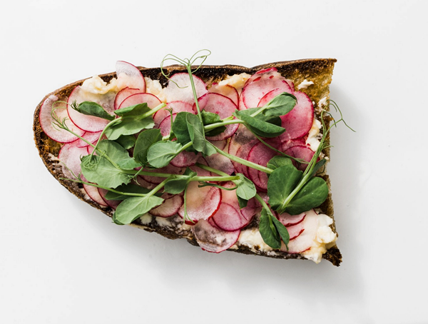 Miso butter on toast with shaved radishes and pea shoots