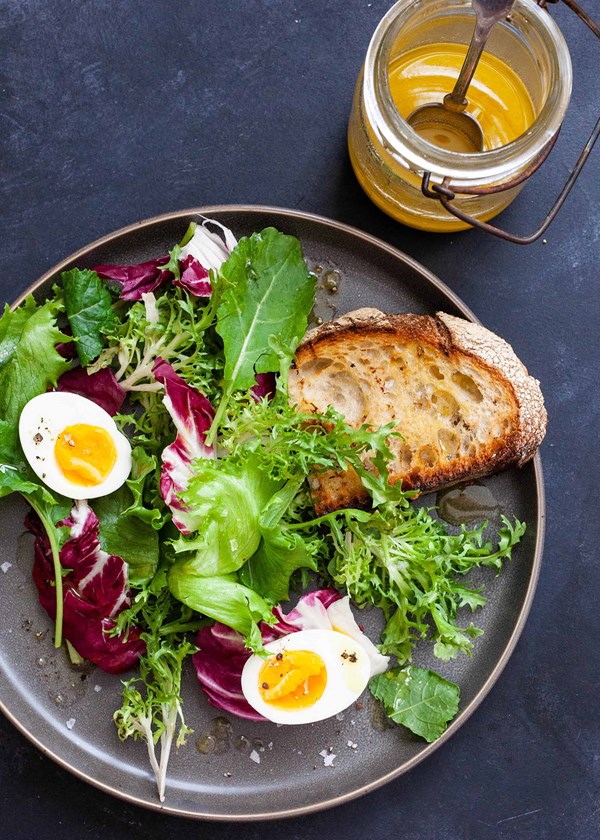 Mixed green salad with honey mustard, eggs, and toast