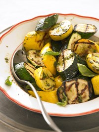 Mixed grill of zucchini and yellow summer squash with pesto oil
