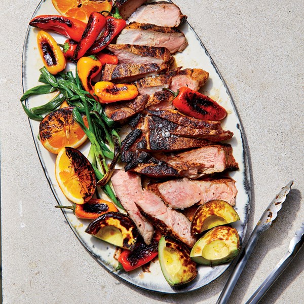 Mojo pork steak with seared avocados and oranges