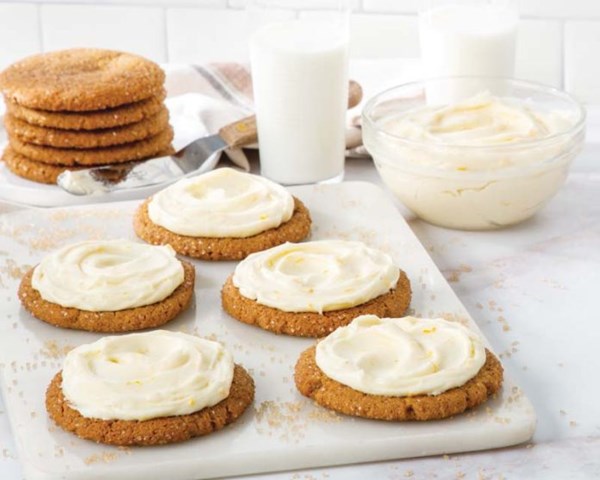 Molasses-ginger crinkle cookies with orange cream frosting