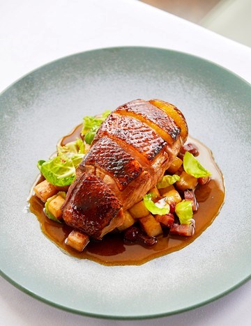 Molasses-glazed duck breast, roasted celeriac, smoked bacon and cranberries