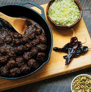 Mole meatballs with wilted cabbage