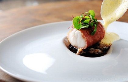 Monkfish wrapped in Parma ham, with red wine jus, lemon sabayon and cockles