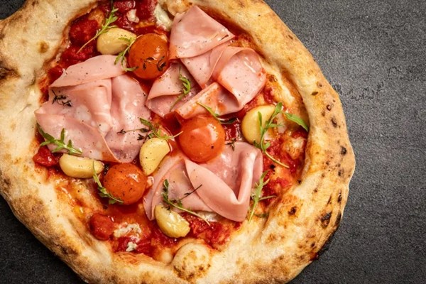Mortadella and confit garlic pizza with Sriracha-cured egg yolks