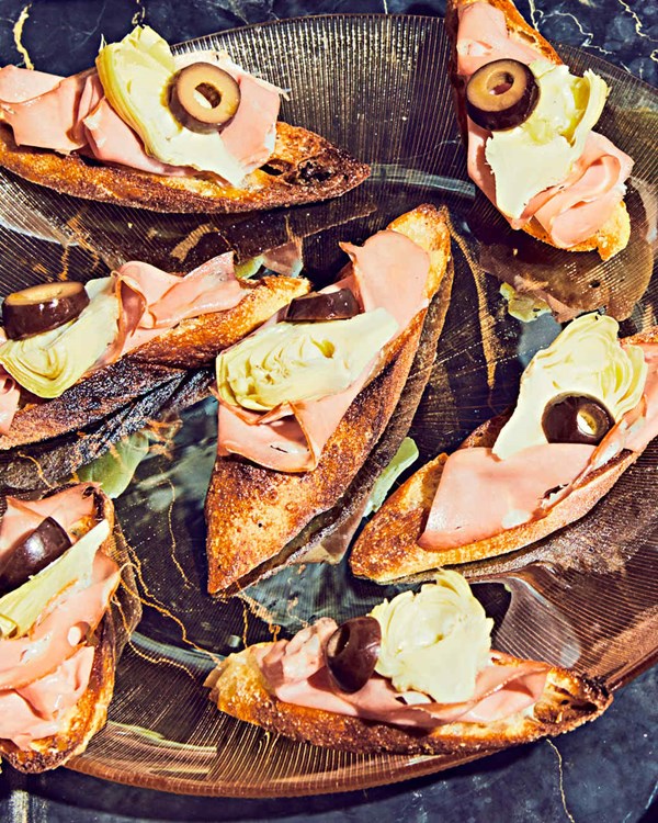 Mortadella, artichoke-heart, and olive crostini