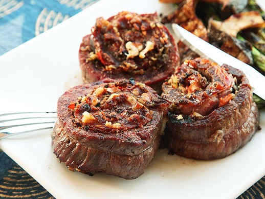 Muffuletta-style grilled stuffed flank steak (Stuffed with salumi, provolone, and olive salad)