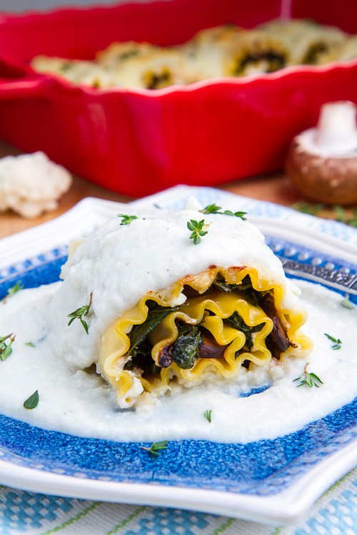 Mushroom and kale lasagna roll ups in creamy Gorgonzola cauliflower sauce