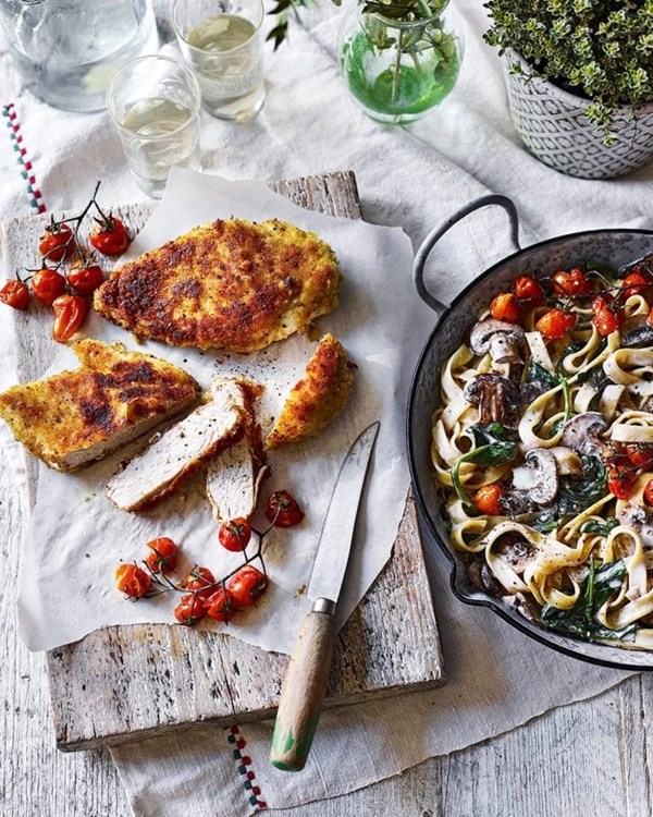 Mushroom tagliatelle Alfredo with roast tomatoes and chicken Milanese