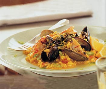 Mussels, clams and shrimp with saffron risotto and green olive relish