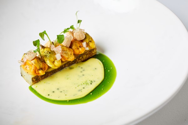 Mussels with charred and pickled cucumber, toasted almonds and curry sauce