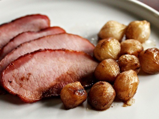Mustard and brown sugar-rubbed ham with balsamic-roasted onions