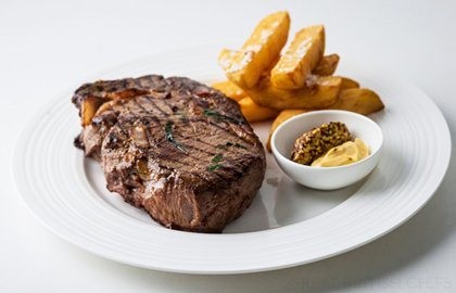 Mustard-infused rib-eye with crispy potatoes