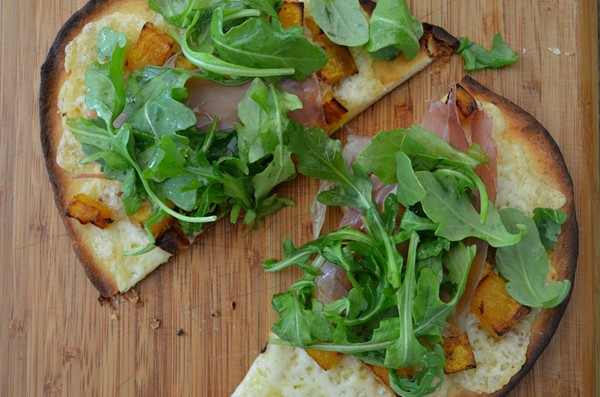 Naan pizzas with butternut squash, prosciutto, and Fontina