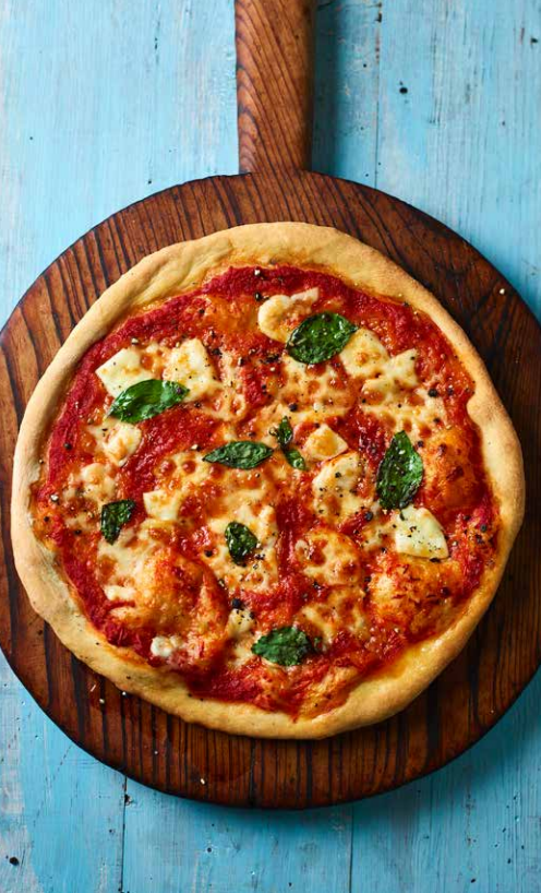 Neapolitan pizza with buffalo mozzarella, tomatoes & basil (Pizza Margherita)