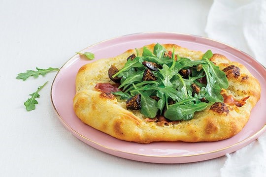 Neapolitan pizza with mascarpone, speck, arugula, and fig