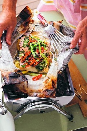 Newspaper-wrapped salmon with fresh herbs, lemon and chilli