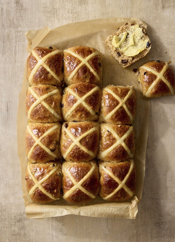 No-knead spicy ginger hot cross buns with rum-soaked fruit and orange vanilla glaze
