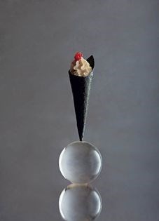 Nori cone with candied ginger, toasted rice cream and raspberry pearls