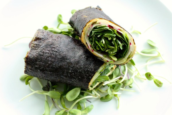 Nori wrap with hummus, cucumbers, radishes, and sprouts