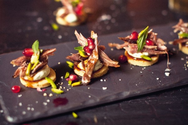 Nutty pistachio biscuits with slow-roasted lamb and pomegranate