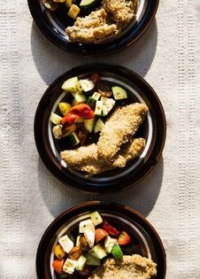 Oatmeal-encrusted perch w/tomato, cucumber + feta salad