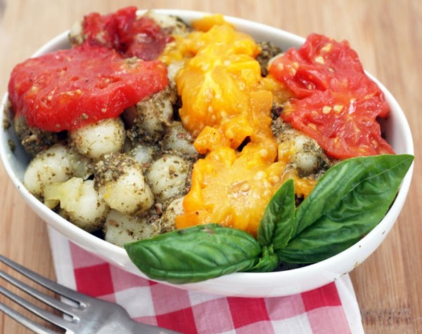 Oil-poached tomatoes over pesto gnocchi