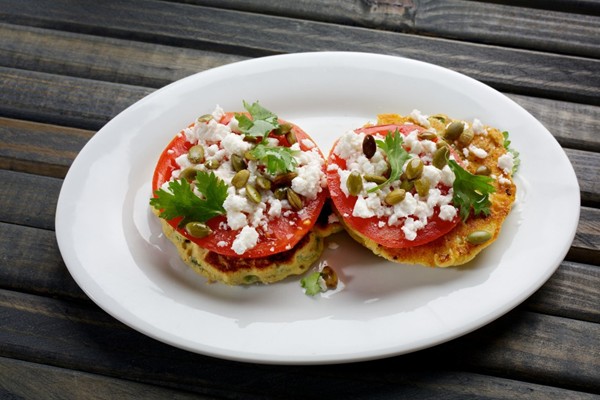 Okra and corn cakes with tomatoes, feta and pepitas